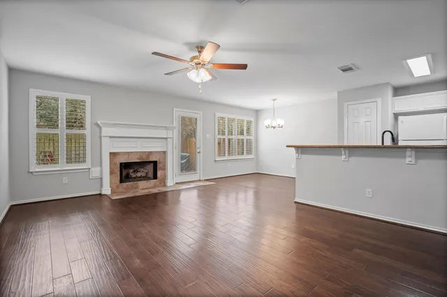 a view of a kitchen with wooden floor and a window