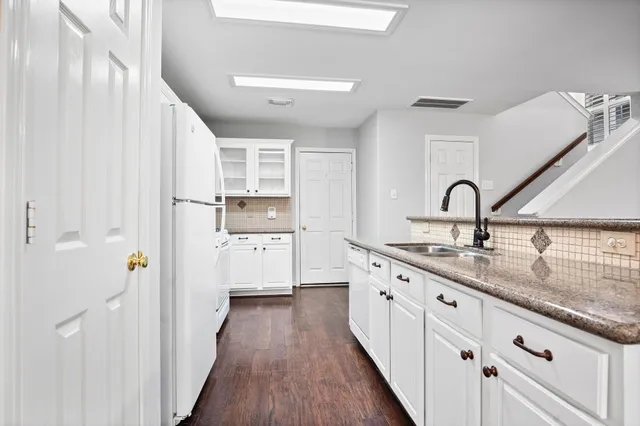 a kitchen with cabinets a sink and appliances