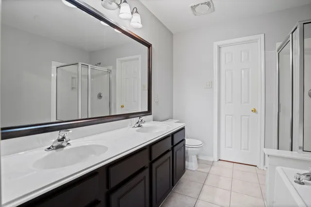 a bathroom with a double vanity sink and mirror