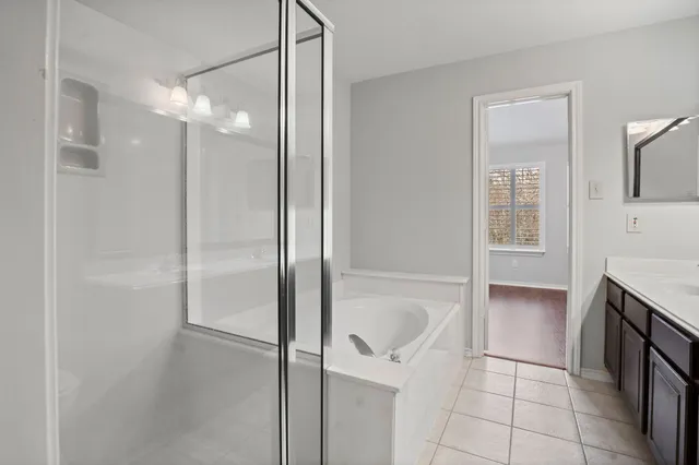 a bathroom with a bathtub and shower