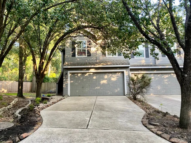 a front view of a house with yard garage and outdoor seating