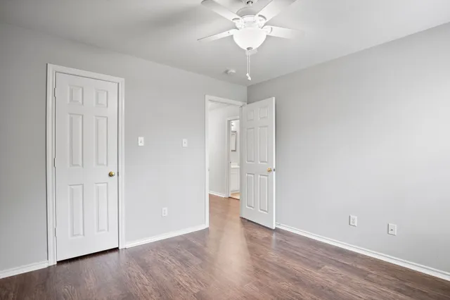 a view of an empty room with wooden floor