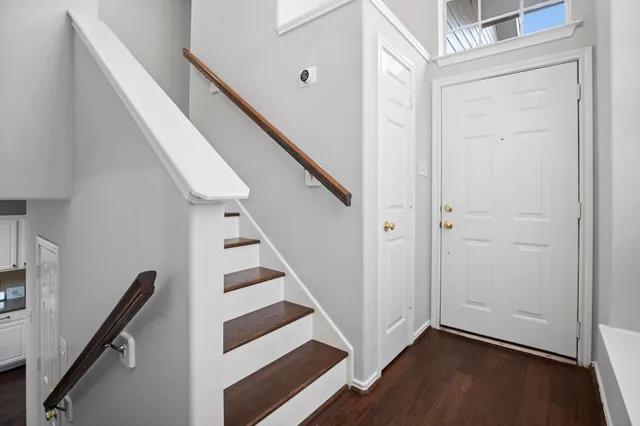 a view of entryway with wooden floor and stairs