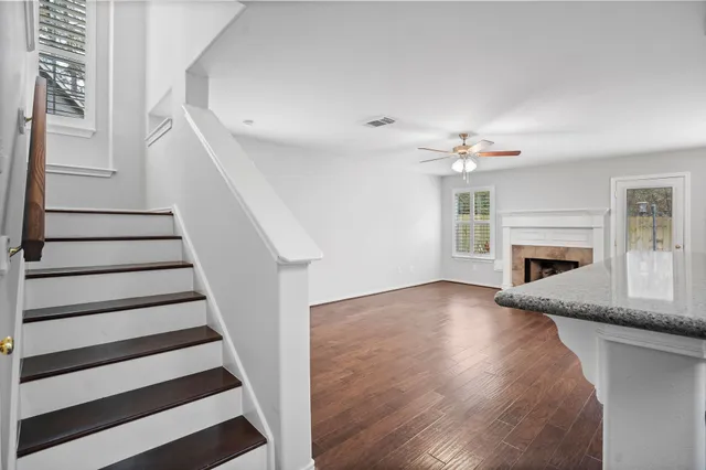 a view of a livingroom with wooden floor and a fireplace