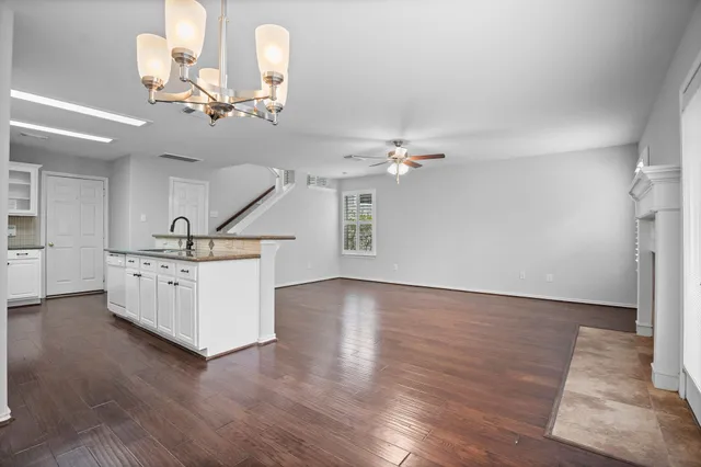 a view of a room with chandelier and wooden floor