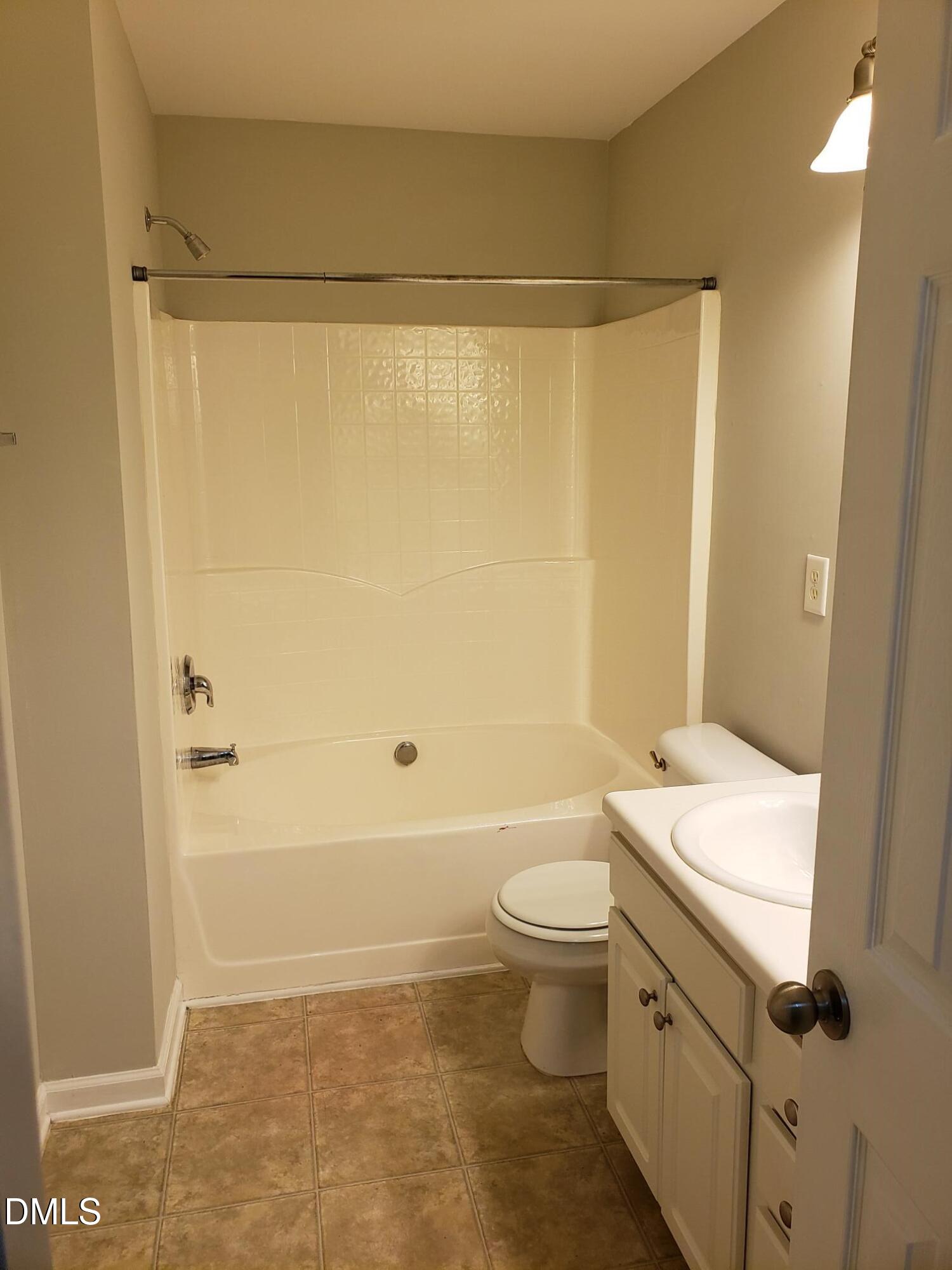 8212 Clasara Circle Raleigh, NC 27613 - Photo 5 of 20 a bathroom with a sink a toilet and shower