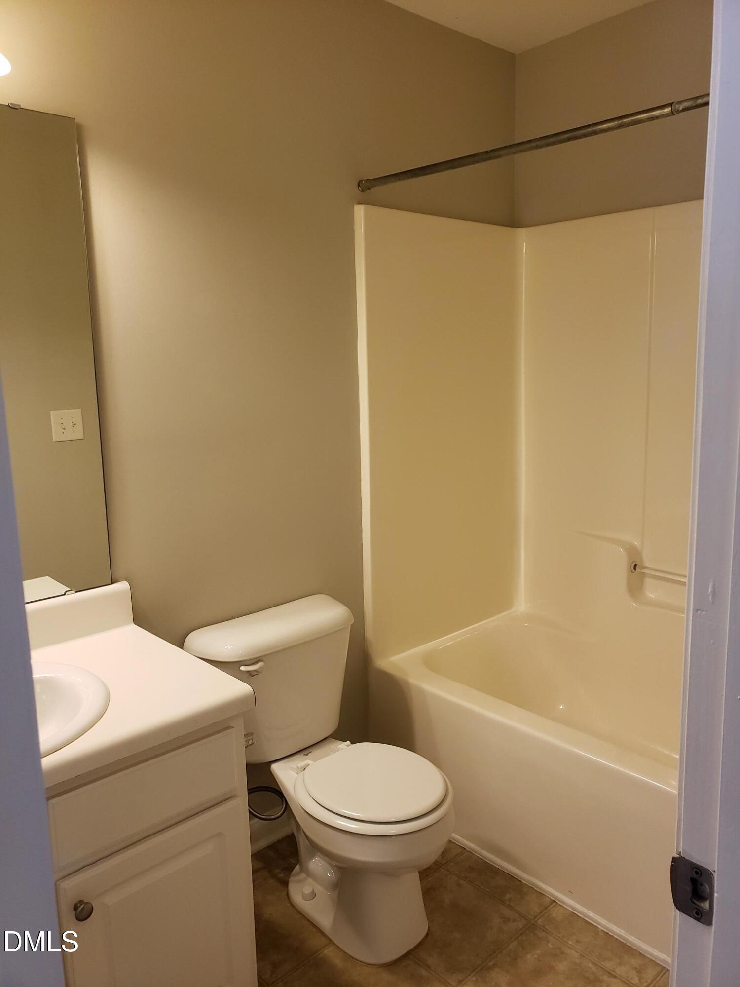 8212 Clasara Circle Raleigh, NC 27613 - Photo 7 of 20 a bathroom with a toilet and a bathtub