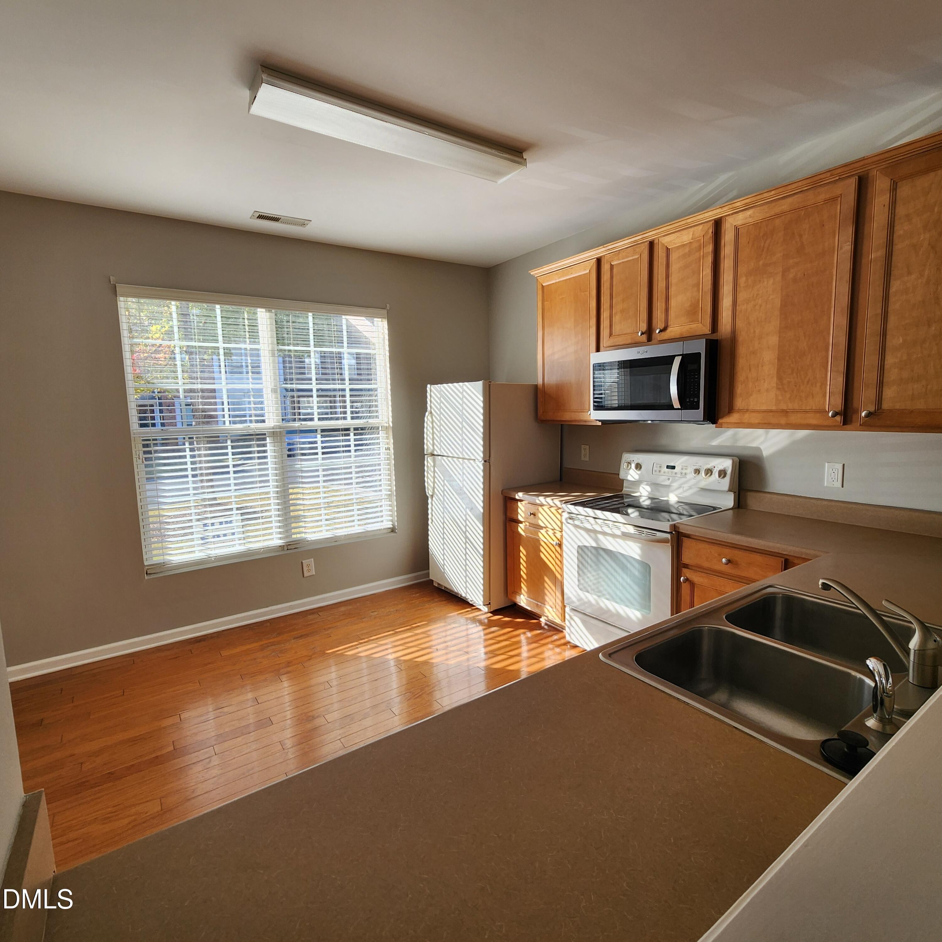 8212 Clasara Circle Raleigh, NC 27613 - Photo 9 of 20 a kitchen that has a sink cabinets counter top space and stainless steel appliances