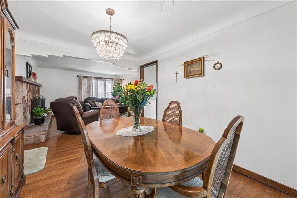 1824 Washington Road Apollo, PA 15613 - Photo 8 of 29 a dining room with furniture a chandelier and wooden floor