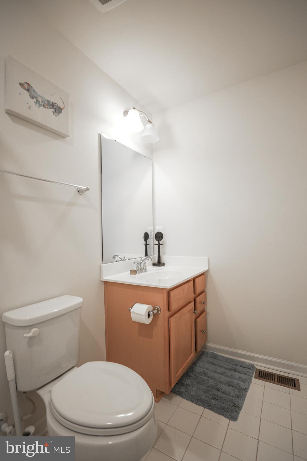 1024 Cook Drive Southeast Washington, DC 20032 - Photo 26 of 44 a bathroom with a sink a toilet and mirror