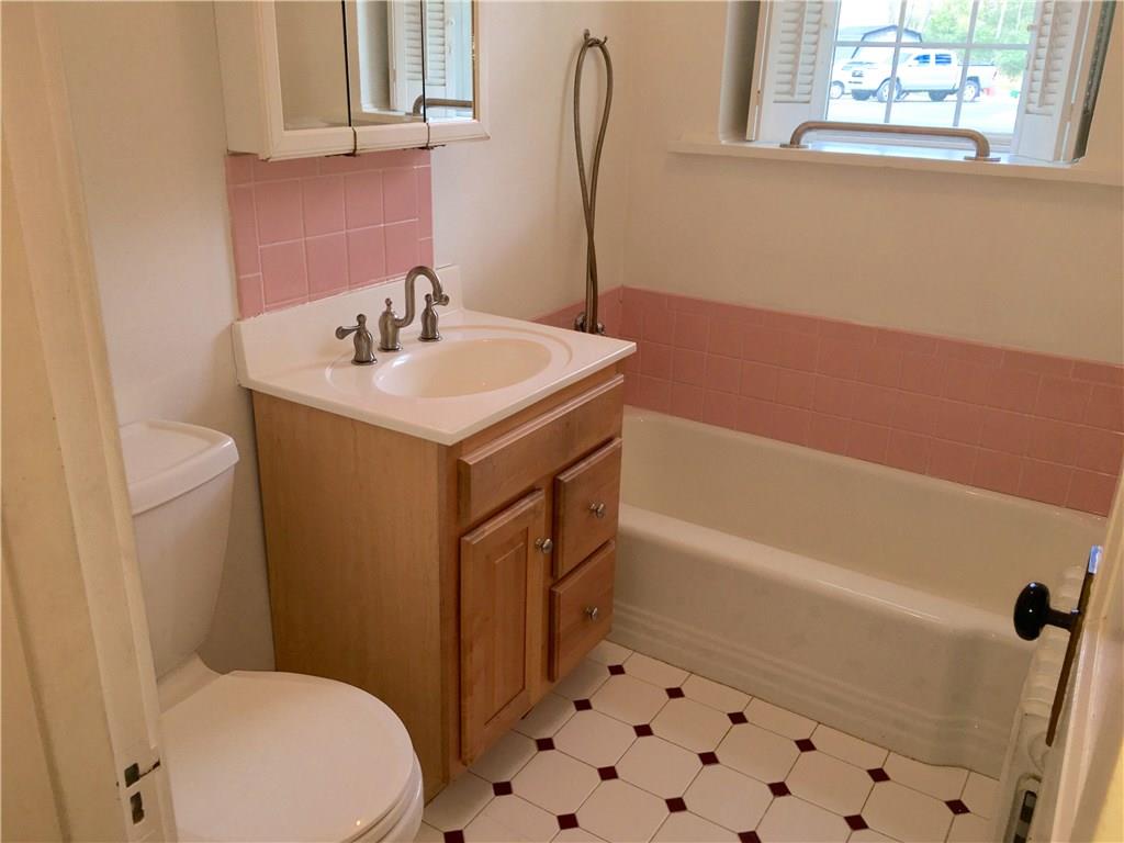 113 Latrobe Steel Road Latrobe, PA 15650 - Photo 13 of 25 First Floor Bathroom has ceramic tile flooring, a cast iron tub and a flexible shower wand.