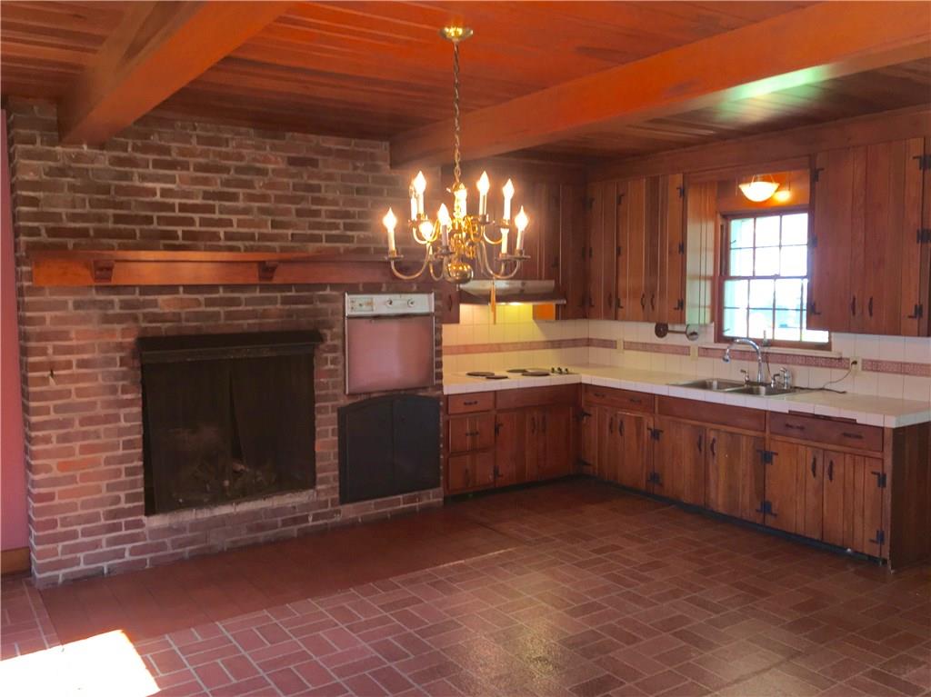 113 Latrobe Steel Road Latrobe, PA 15650 - Photo 6 of 25 Wonderful Gas Fireplace with built-in Wall Oven and Electric Cooktop & Range Hood.