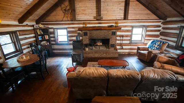 a living room with furniture a fireplace and a window