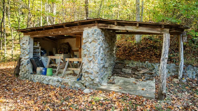 a view of a house with a yard and sitting area