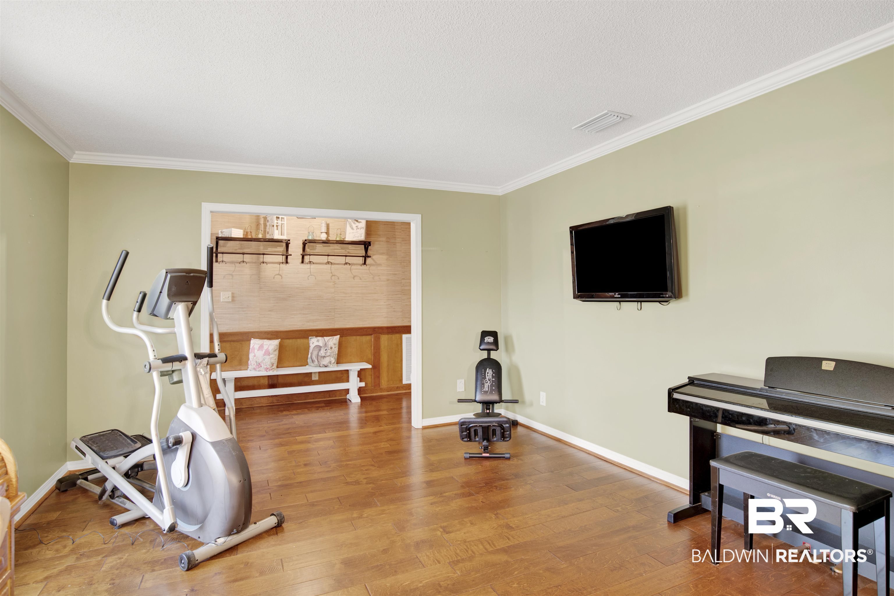 7431 Summer Court Mobile, AL 36695 - Photo 9 of 37 Workout area with ornamental molding, wood finished floors, and baseboards