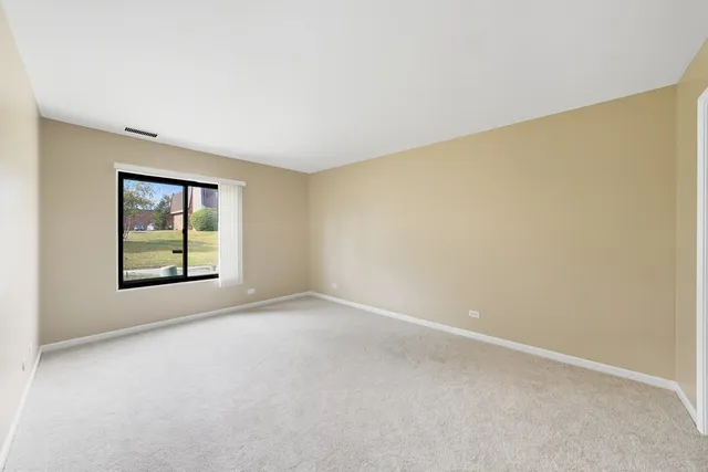 a view of an empty room with windows