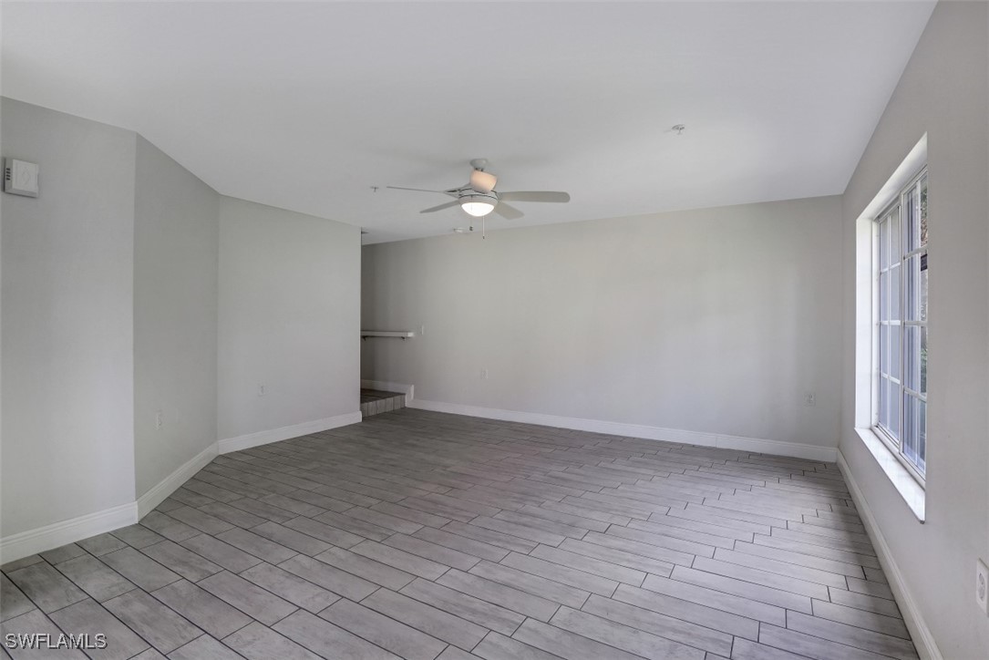 9465 Ivy Brook Run, Unit 901 Fort Myers, FL 33913 - Photo 12 of 24 wooden floor in an empty room with a window