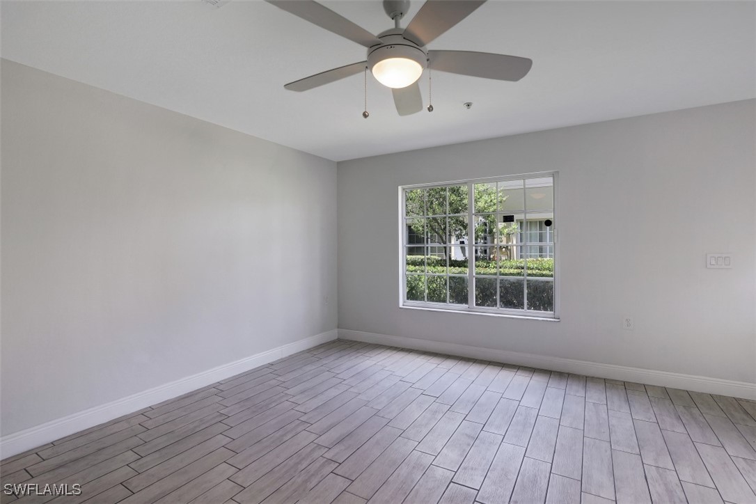 9465 Ivy Brook Run, Unit 901 Fort Myers, FL 33913 - Photo 13 of 24 wooden floor in an empty room with a window