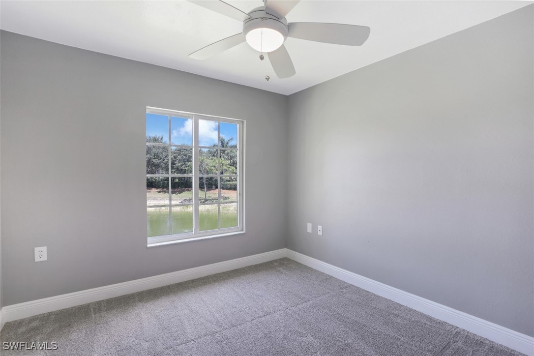 9465 Ivy Brook Run, Unit 901 Fort Myers, FL 33913 - Photo 15 of 24 an empty room with a window and a fan