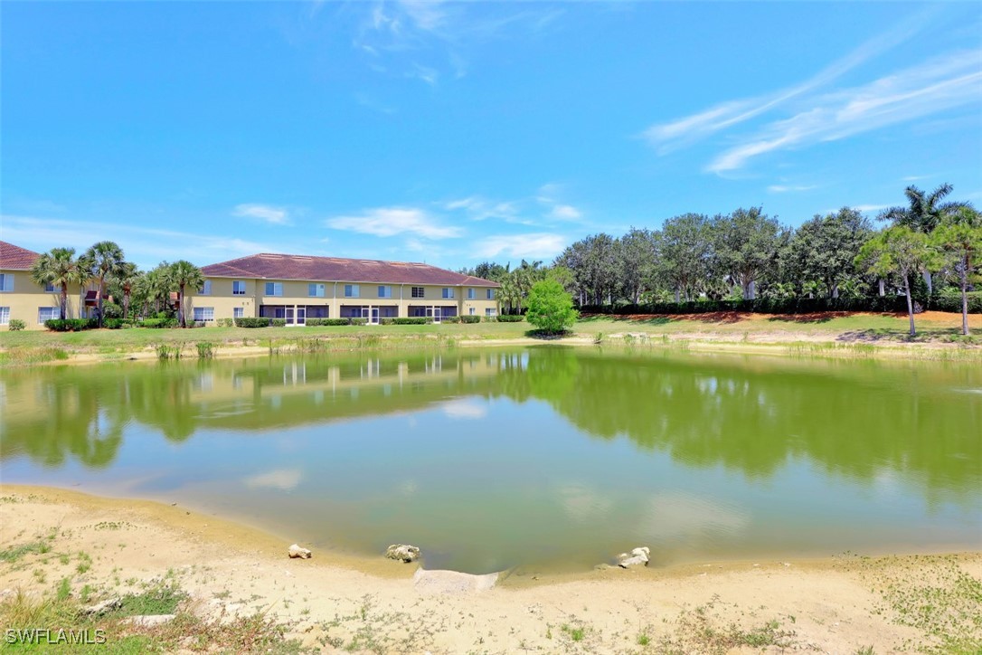 9465 Ivy Brook Run, Unit 901 Fort Myers, FL 33913 - Photo 20 of 24 a view of a lake with houses in the back
