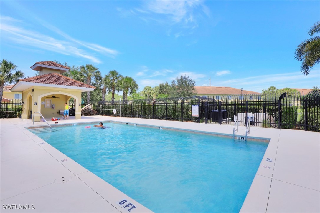 9465 Ivy Brook Run, Unit 901 Fort Myers, FL 33913 - Photo 21 of 24 a swimming pool with outdoor seating and yard