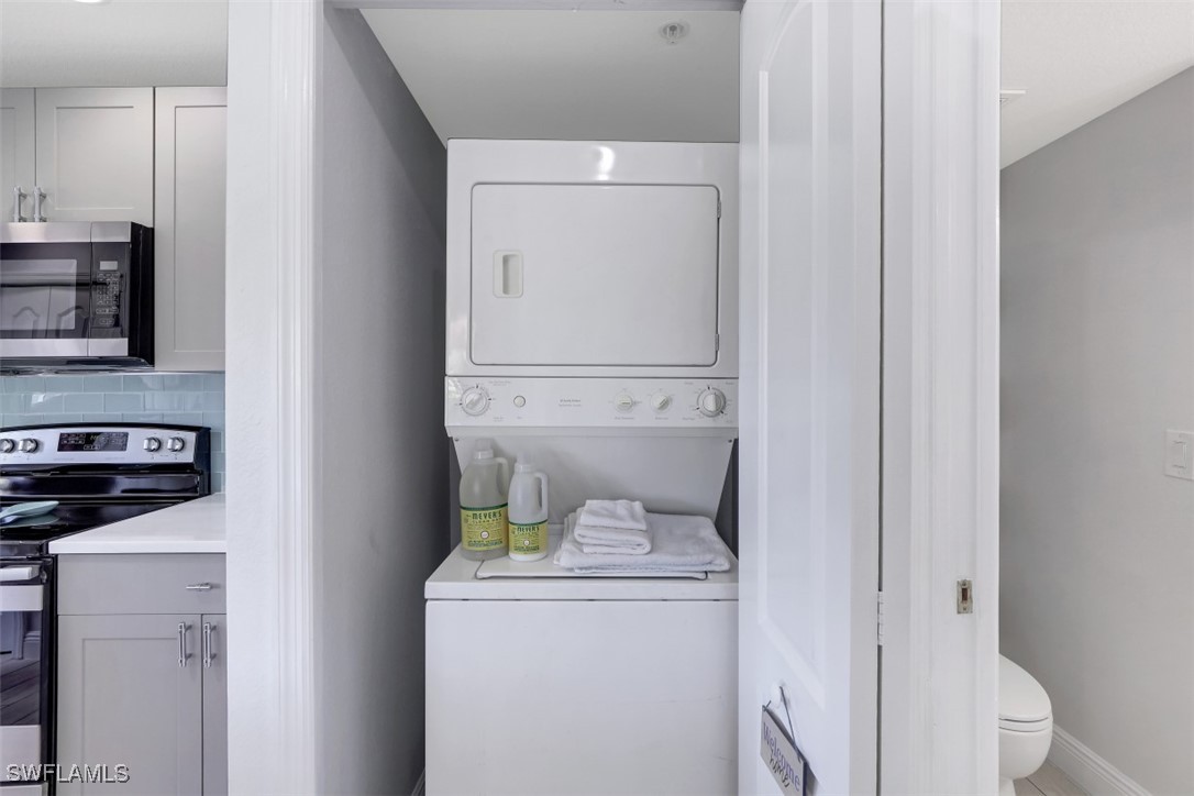 9465 Ivy Brook Run, Unit 901 Fort Myers, FL 33913 - Photo 6 of 24 a utility room with dryer and washer