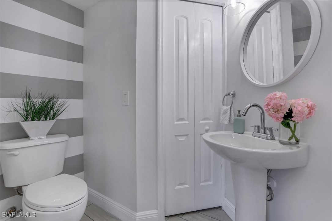 9465 Ivy Brook Run, Unit 901 Fort Myers, FL 33913 - Photo 7 of 24 a bathroom with a toilet sink and mirror