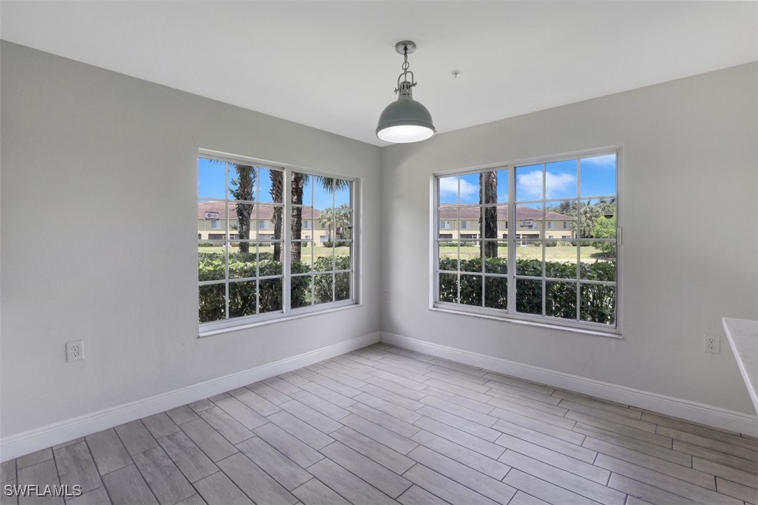 9465 Ivy Brook Run, Unit 901 Fort Myers, FL 33913 - Photo 9 of 24 a view of empty room with wooden floor and fan
