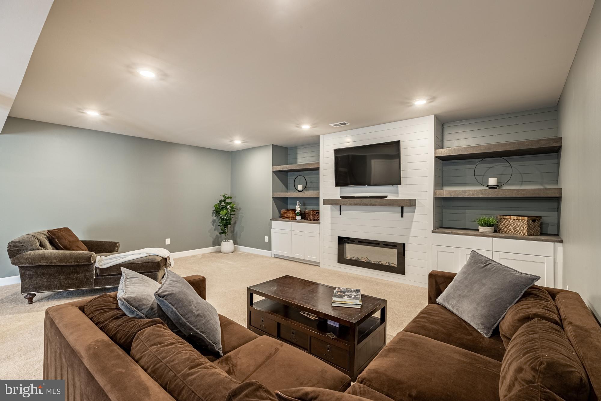 23597 Amesfield Place Aldie, VA 20105 - Photo 51 of 78 Feature wall with fireplace, built-in shelving
