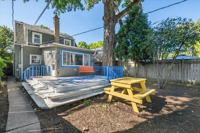 a view of a house with pool and chairs