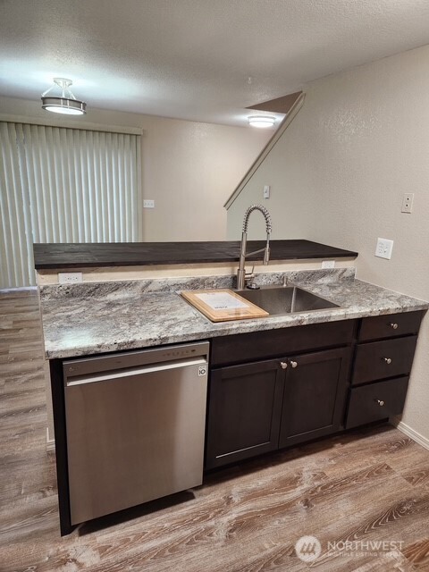 12303 Alexander Road Everett, WA 98204 - Photo 11 of 19 a kitchen with a sink and cabinets
