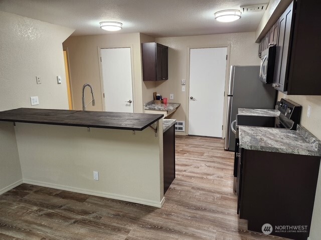 12303 Alexander Road Everett, WA 98204 - Photo 12 of 19 a kitchen with stainless steel appliances granite countertop a sink and a stove top oven