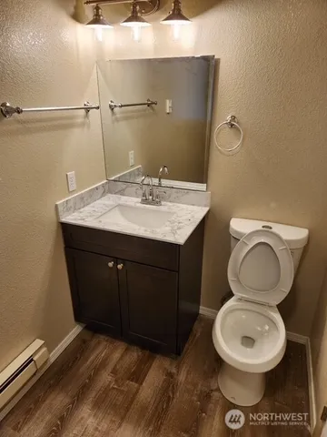 a bathroom with a sink vanity mirror and toilet