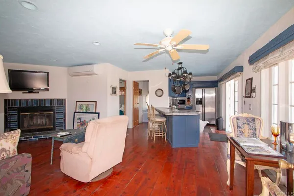 a living room with furniture a fireplace and a flat screen tv