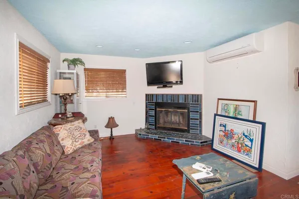 a living room with furniture fireplace and flat screen tv