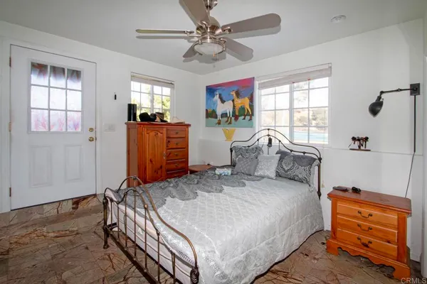 a bedroom with furniture and a window
