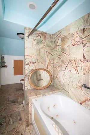 a bathroom with a tub and shower