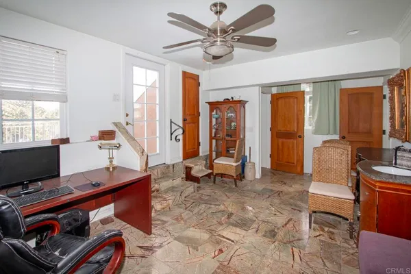 a living room with furniture a flat screen tv and a window