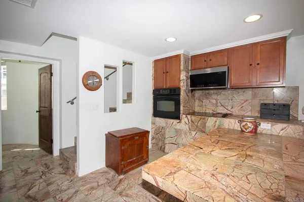 a kitchen with a refrigerator and a stove top oven