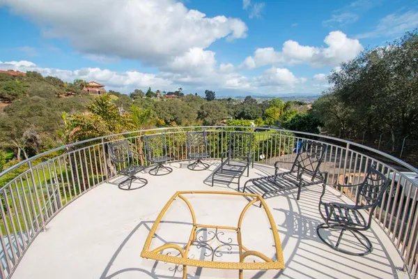 a view of a balcony with mountain view and wooden floor