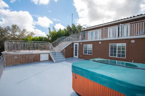 a view of a house with a deck and a yard