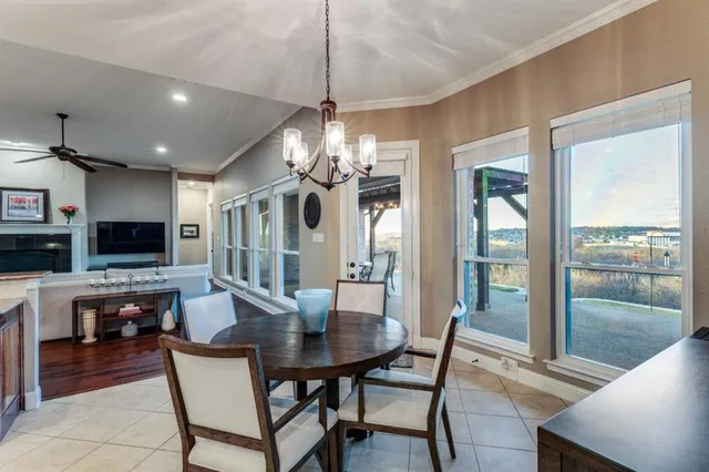 a view of a dining room with furniture wooden floor and chandelier