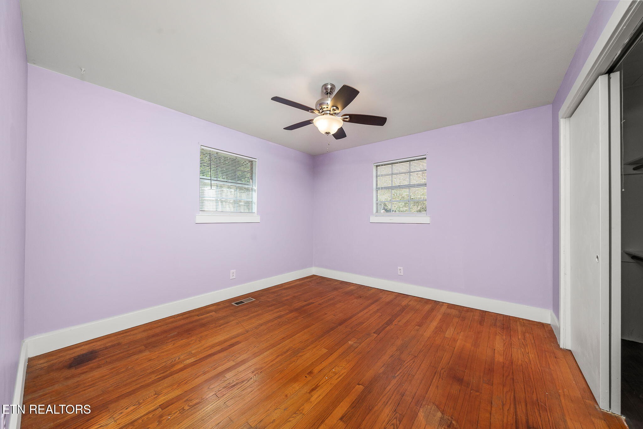 287 Watson Avenue Spring City, TN 37381 - Photo 17 of 24 an empty room with wooden floor and windows