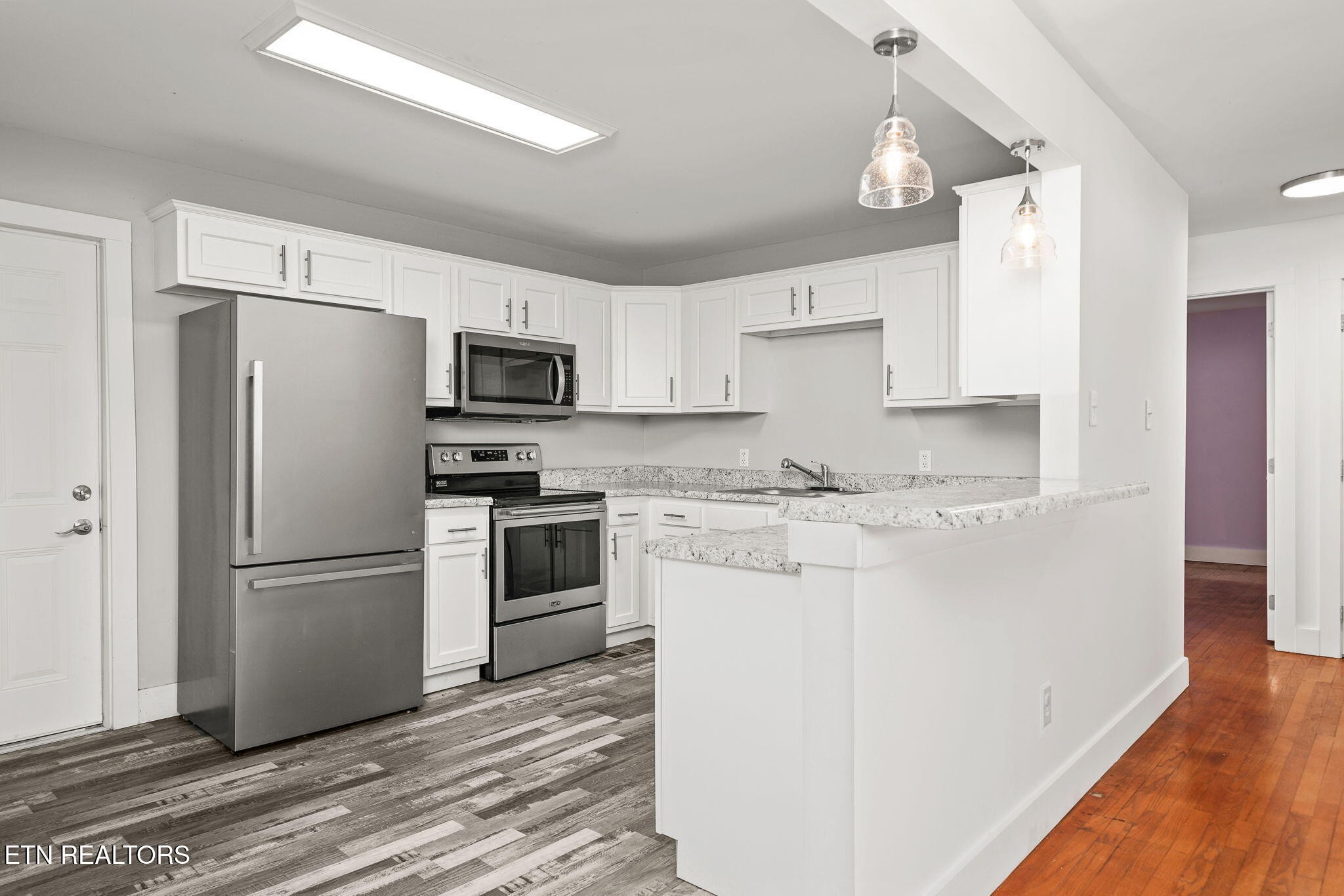 287 Watson Avenue Spring City, TN 37381 - Photo 5 of 24 a kitchen with a refrigerator stove and wooden floor