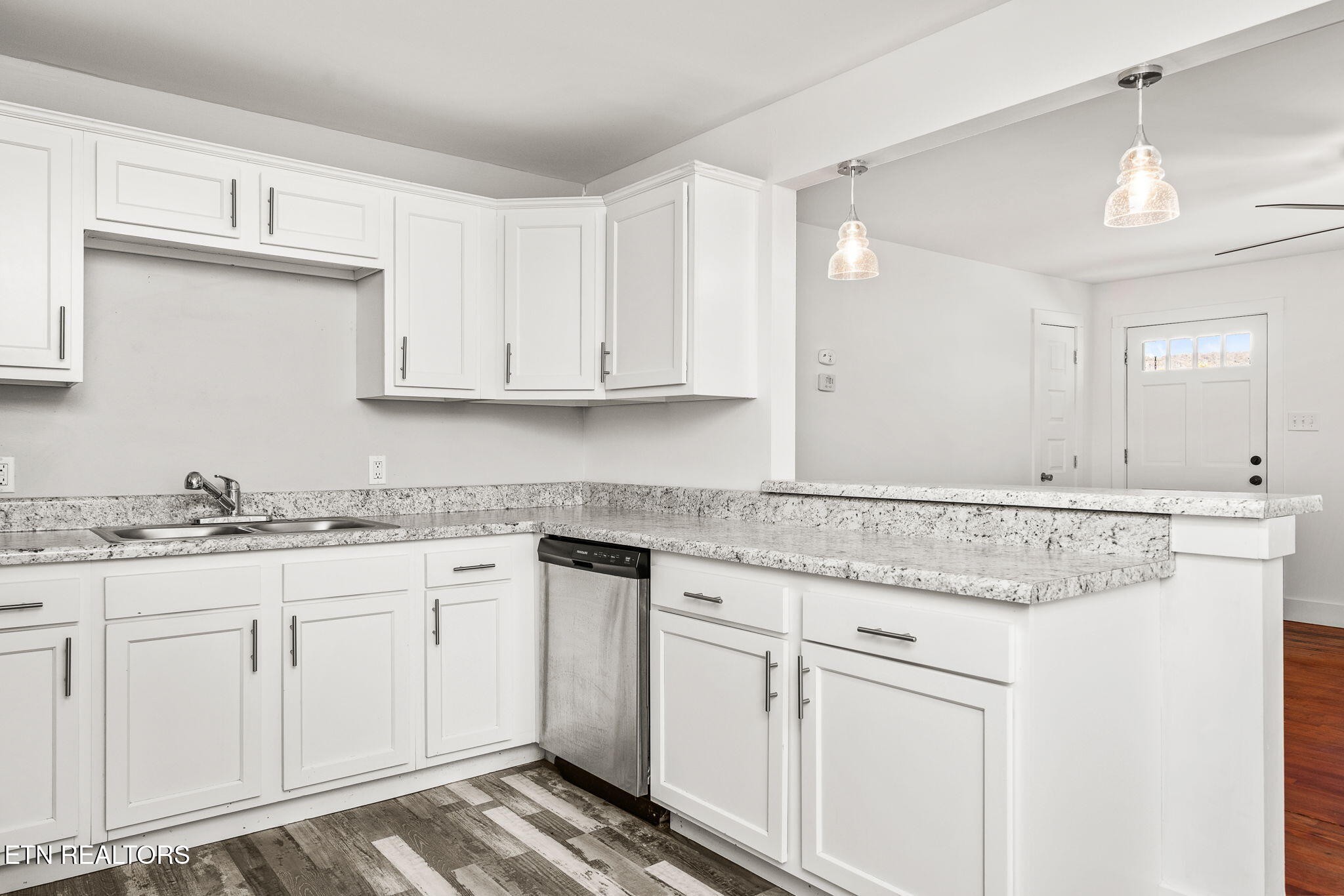 287 Watson Avenue Spring City, TN 37381 - Photo 7 of 24 a kitchen with granite countertop white cabinets and a sink