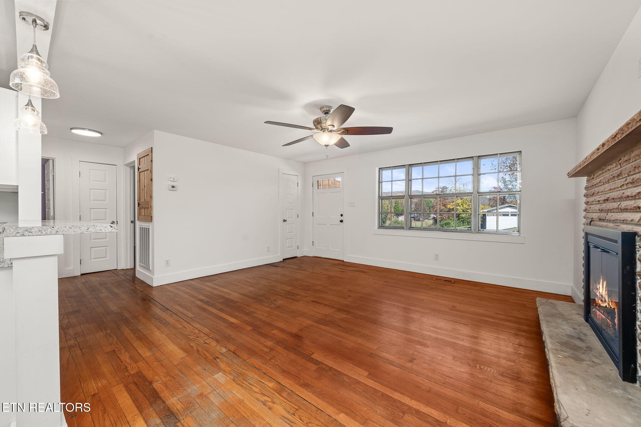 287 Watson Avenue Spring City, TN 37381 - Photo 9 of 24 a view of an empty room with a window and a kitchen