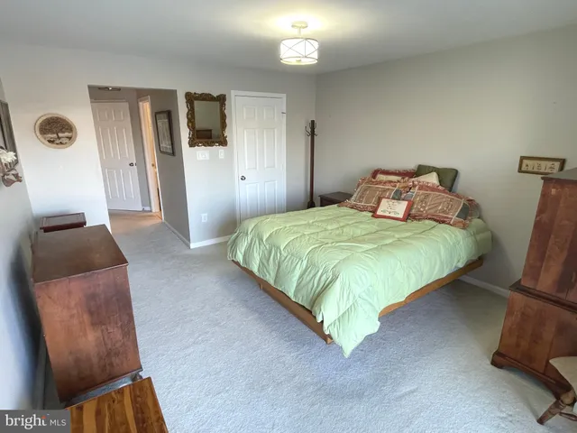 a bedroom with a bed and mirror