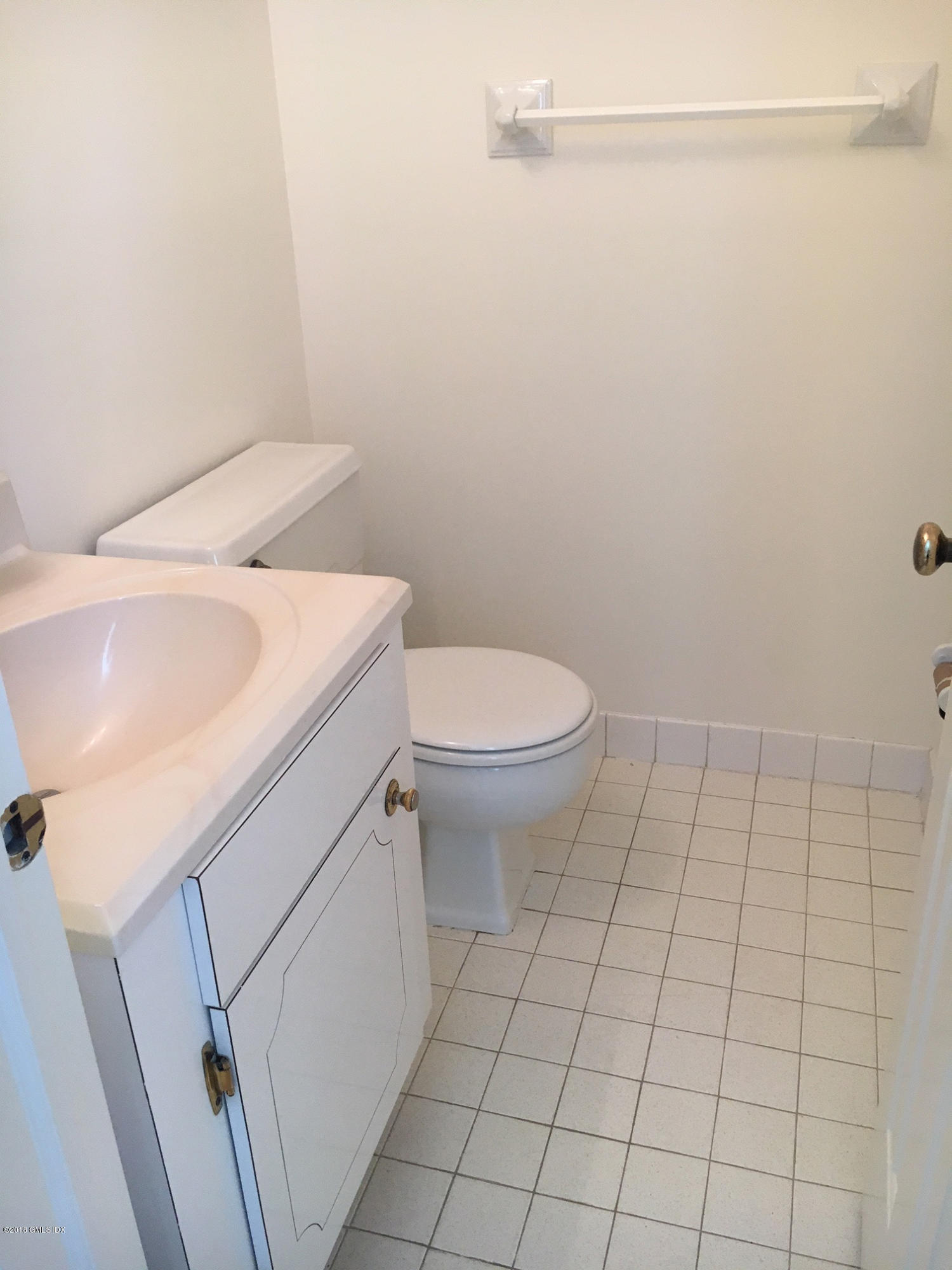 140 Field Point Road, Unit 2 Greenwich, CT 06830 - Photo 11 of 14 a view of a bathroom with white tiles