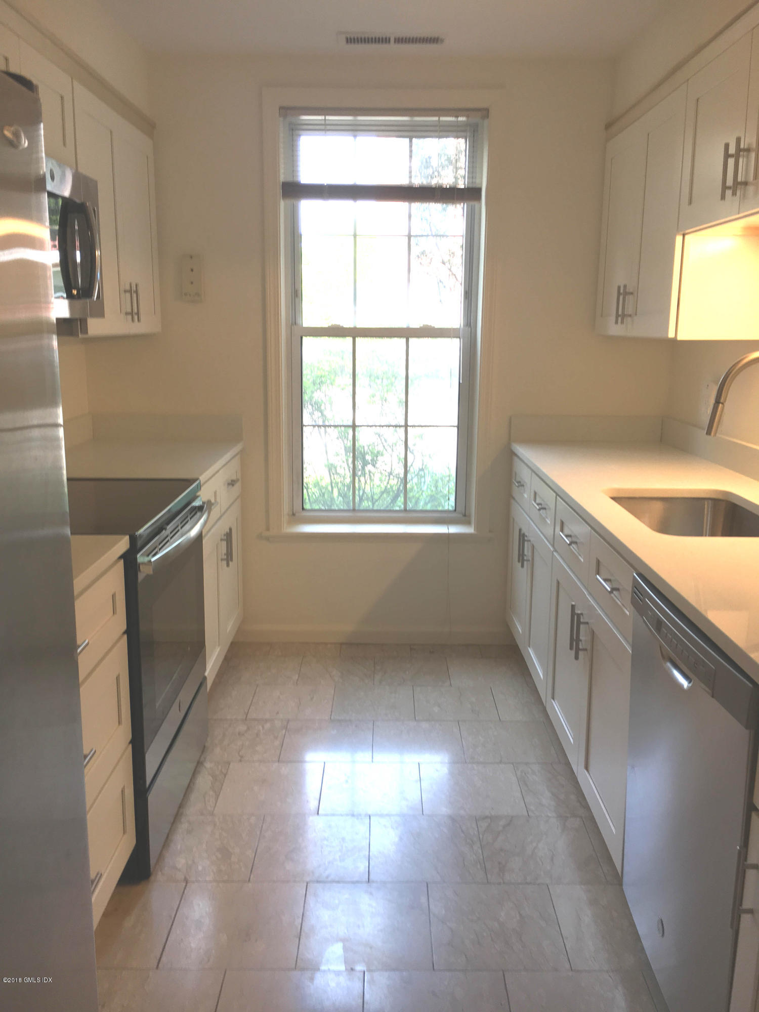 140 Field Point Road, Unit 2 Greenwich, CT 06830 - Photo 5 of 14 a kitchen with a sink and a window