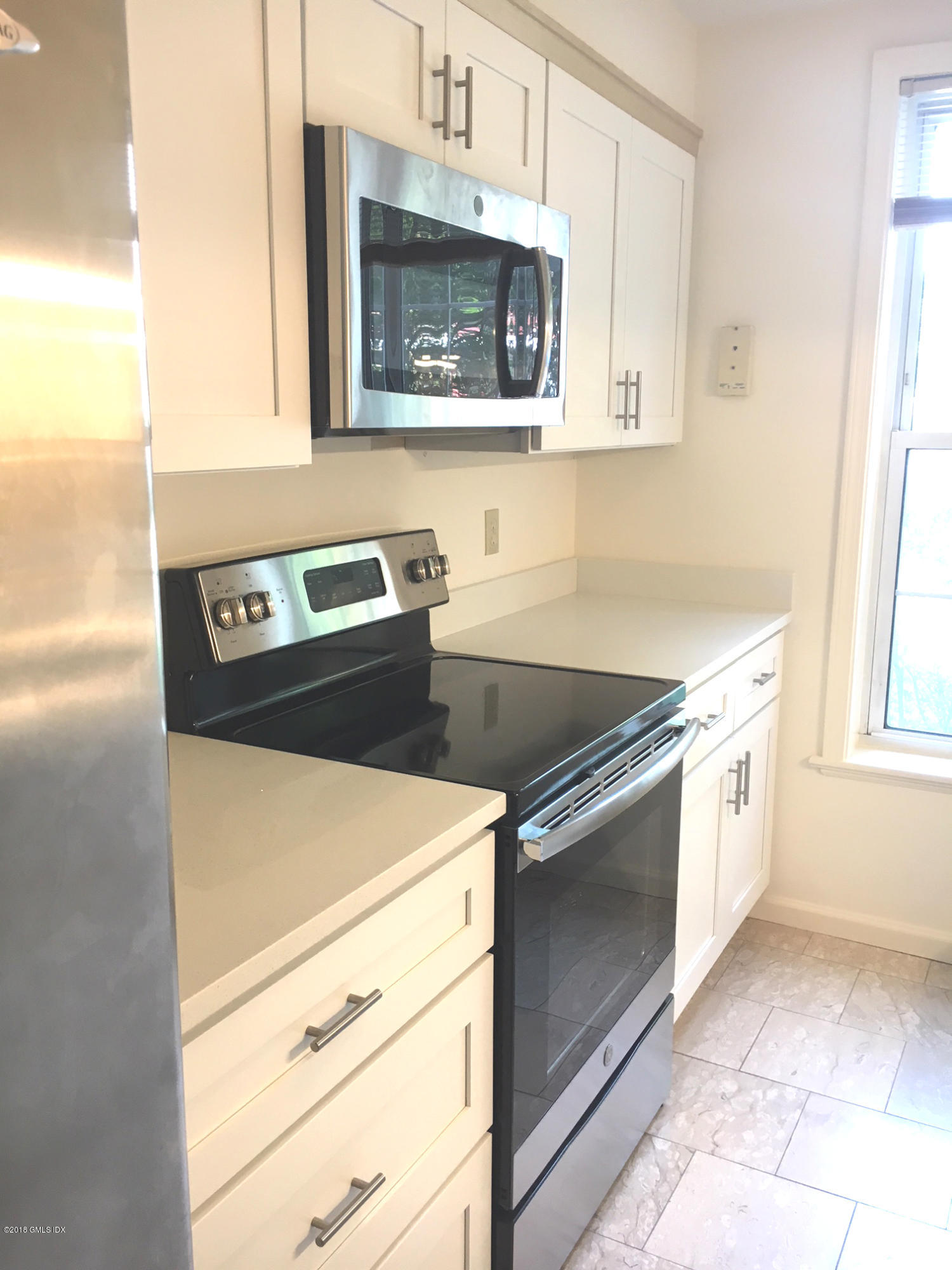 140 Field Point Road, Unit 2 Greenwich, CT 06830 - Photo 6 of 14 a kitchen with stainless steel appliances a stove microwave and sink